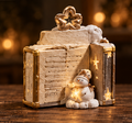 Cream book-shaped Christmas decoration with gold-tone trim and a snowman holding a glowing star.
